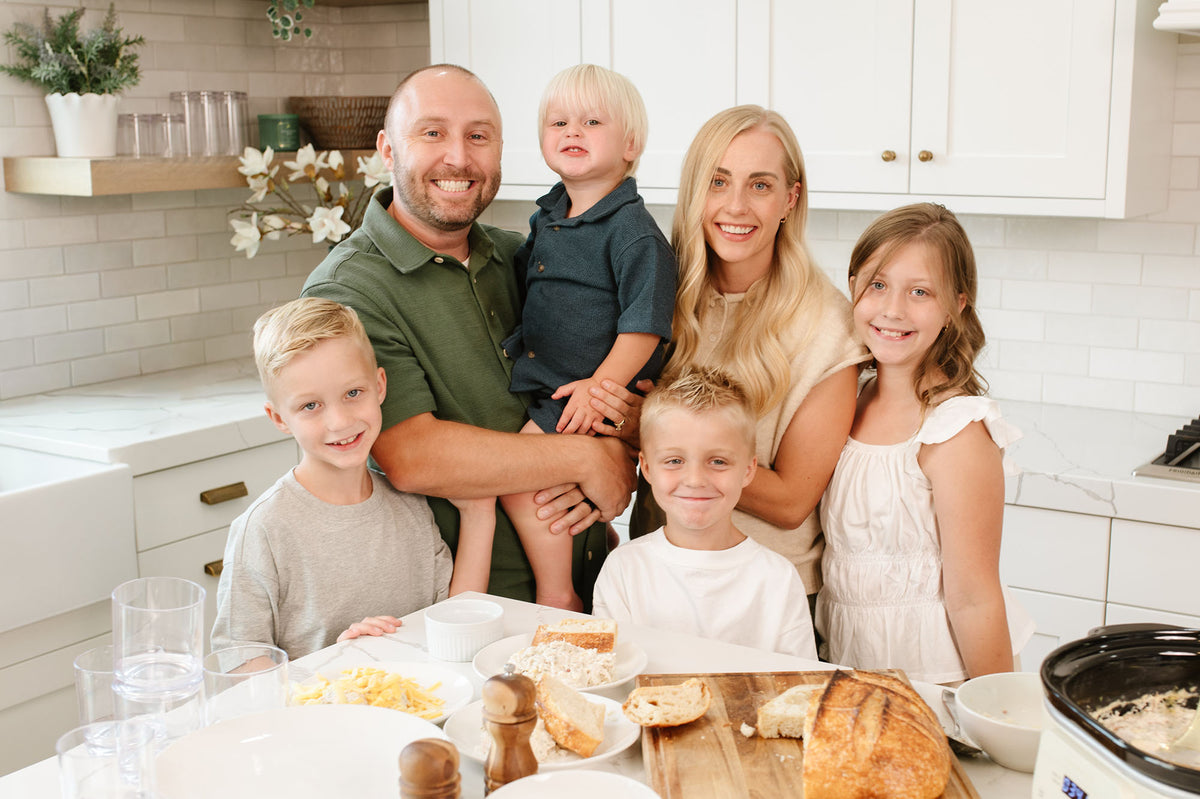 Jackson Family standing in the kitchen cooking Beehive Meals. Allyse Jackson, founder of Beehive Meals. 