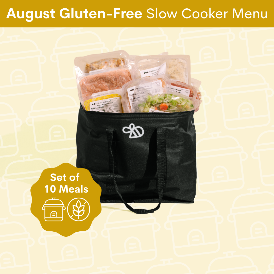 A black insulated cooler bag filled with packaged prepared meals, shown on a pale yellow background with a top banner reading 'August Gluten-Free Slow Cooker Menu' and a yellow badge that says 'Set of 10 Meals'.