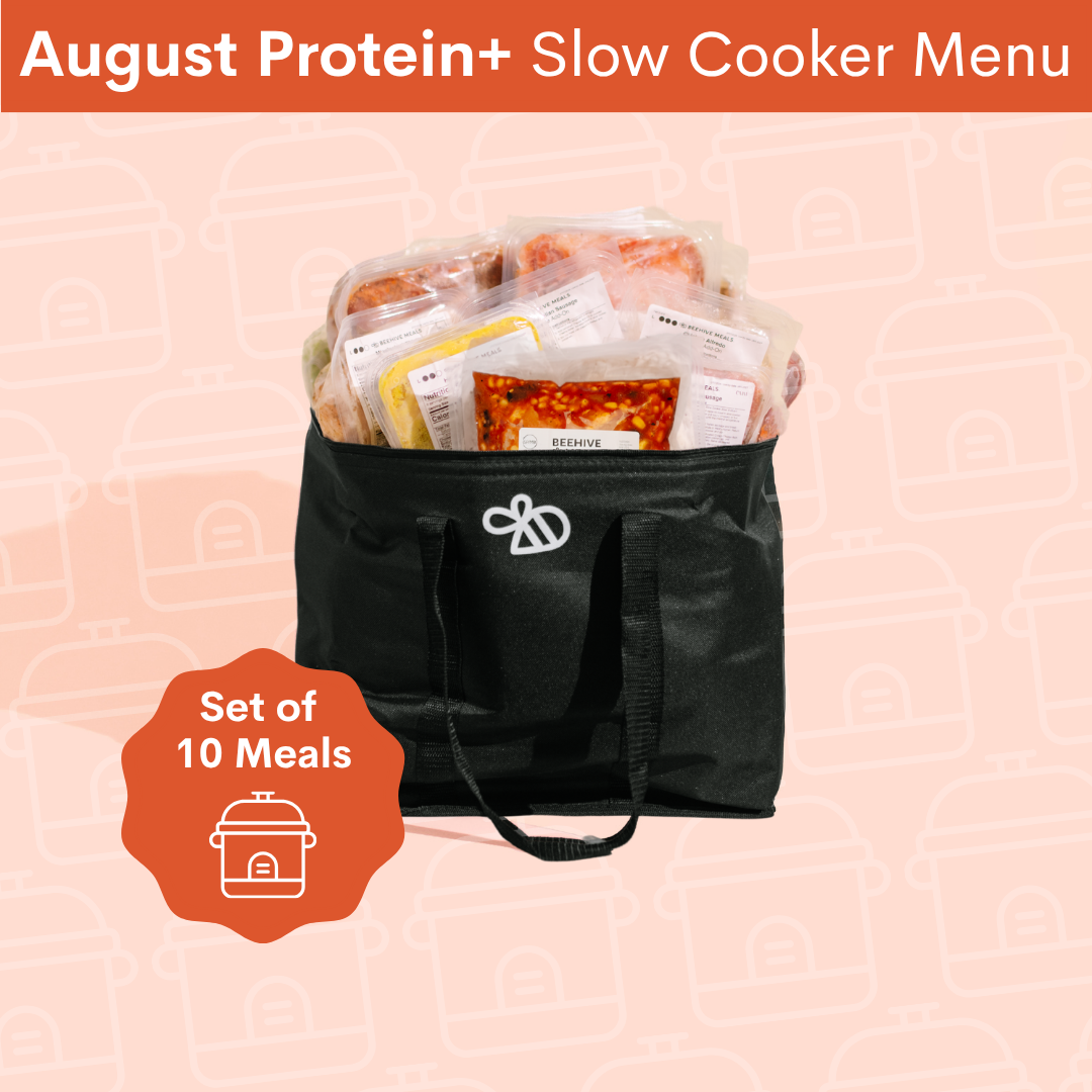 A black insulated cooler bag filled with packaged meals, shown on a pale pink background with an orange banner reading 'August Protein+ Slow Cooker Menu' and an orange badge that says 'Set of 10 Meals'.