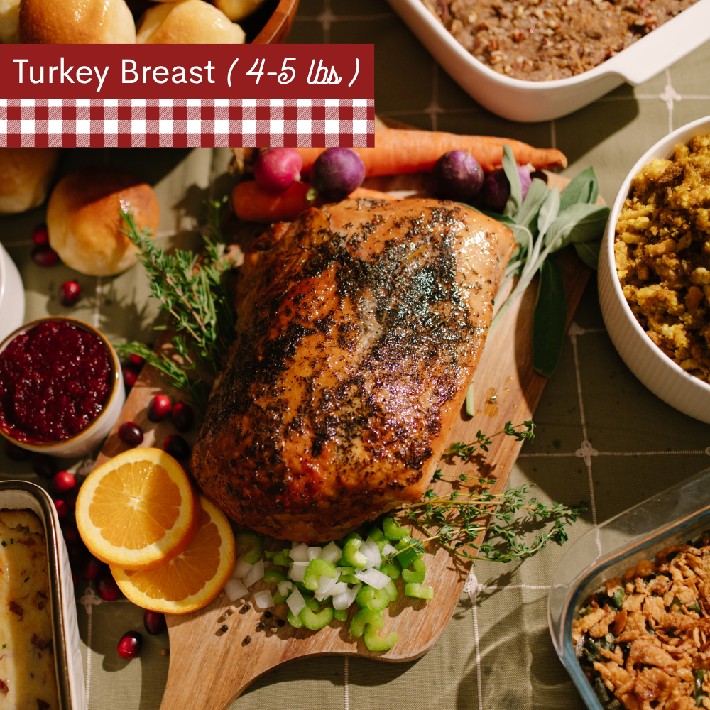 Image of cooked Turkey breast on a wooden cutting board with carrots, oranges, celery and herbs surrounding the turkey all on a green plaid table cloth. A red-and-white gingham banner at the top left reads 'Turkey breast 4-5lbs).'