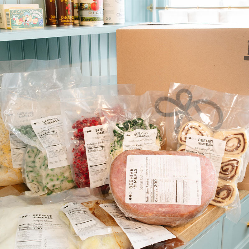 Assorted packaged Easter food items on a wooden surface with a blue cabinet in the background.
