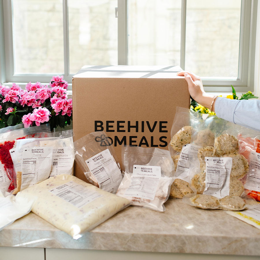 Beehive Meals packaging on a table with a cardboard box labeled 'Beehive Meals'.