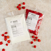 Two packages of Beehive Meals with frozen raspberries on a light surface