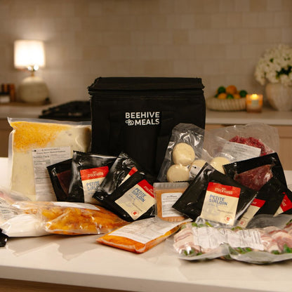 Photo of a Beehive Meals bag sitting on a counter with all of the uncooked products surrounding the bag