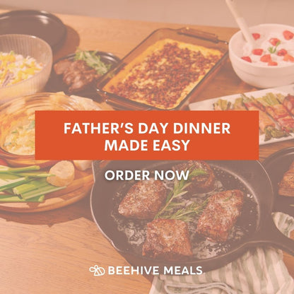 Table with various dishes and a promotional banner for Beehive Meals Father's Day dinner that reads "Father's Day Dinner Made Easy. Order Now." 
