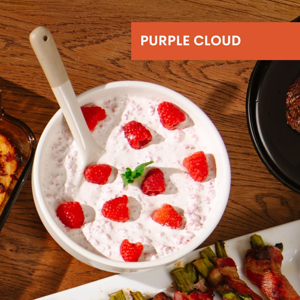 Bowl of Purple Cloud dessert with raspberries on a wooden table, labeled 'Purple Cloud'.
