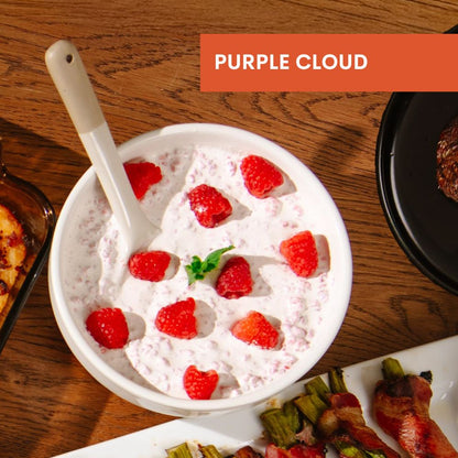 Bowl of Purple Cloud dessert with raspberries on a wooden table, labeled 'Purple Cloud'.