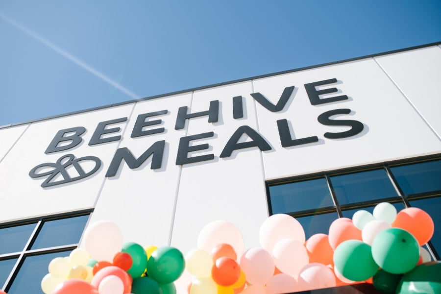Beehive Meals building with colorful balloons in front