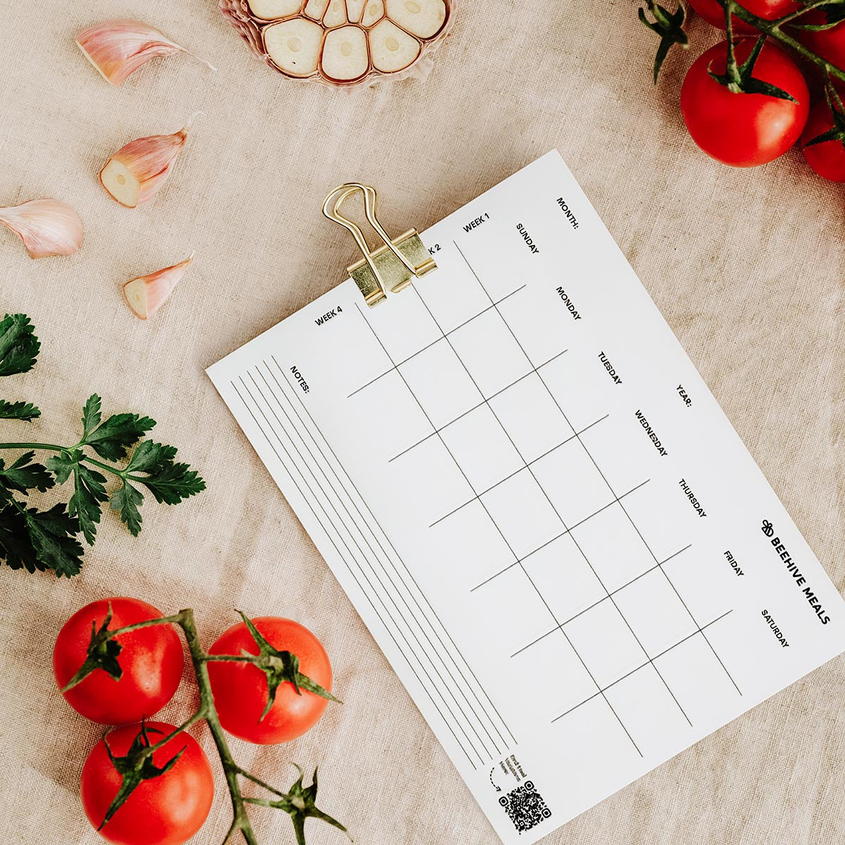 Weekly meal planner sheet with vegetables on a beige surface
